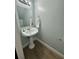 Cozy bathroom featuring a pedestal sink, mirror, and light gray paint at 3960 Willow Trail Run # 45, Port Orange, FL 32127