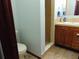 Well-lit bathroom with a walk-in shower, wood-style flooring, and a white toilet at 3960 Willow Trail Run # 45, Port Orange, FL 32127