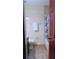 Bathroom with wood-style flooring, a white tile tub and toilet, and a vanity sink at 3960 Willow Trail Run # 45, Port Orange, FL 32127