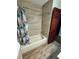 Bathroom with tub and shower, wood-look floors, and decorative shower curtain at 3960 Willow Trail Run # 45, Port Orange, FL 32127