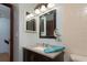 Bathroom with a dark wood vanity with sink, neutral walls and trim, and decorative wall items at 3960 Willow Trail Run # 45, Port Orange, FL 32127