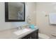 Bathroom featuring a vanity with a framed mirror, light blue walls, and white tiles at 3960 Willow Trail Run # 45, Port Orange, FL 32127