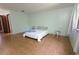 Simple bedroom with tile floors, a full bed, a window with curtain, and minimalist furnishings at 3960 Willow Trail Run # 45, Port Orange, FL 32127