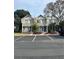 Townhome complex with gray siding, blue doors, and parking lot in front at 3960 Willow Trail Run # 45, Port Orange, FL 32127