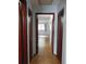 Hallway with tile flooring and dark wooden closets leading to a bright room at 3960 Willow Trail Run # 45, Port Orange, FL 32127