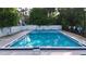 Community pool surrounded by lounge chairs, lush landscaping and tall trees at 3960 Willow Trail Run # 45, Port Orange, FL 32127