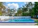 Refreshing blue swimming pool with a white fence, palm trees, and lounge chairs, perfect for relaxing outdoors at 3960 Willow Trail Run # 45, Port Orange, FL 32127