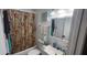 Bathroom with a floral shower curtain, a mirror and a single sink vanity at 411 Banana Cay Dr # C, South Daytona, FL 32119