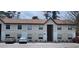 Exterior of a two-story condo building with neutral paint, brown roof, and ample parking at 411 Banana Cay Dr # C, South Daytona, FL 32119