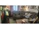 Living room featuring a gray sectional couch, wooden floors, and a large window at 411 Banana Cay Dr # C, South Daytona, FL 32119