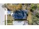 Bird's eye view of a house featuring a dark roof, a white driveway, and green lawns at 414 Ellsworth St, Daytona Beach, FL 32114