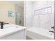 Beautiful bathroom with marble tiled shower/tub and modern white countertop vanity at 414 Ellsworth St, Daytona Beach, FL 32114