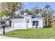 Charming single-story home with a white exterior, attached garage, and well-manicured front yard at 414 Ellsworth St, Daytona Beach, FL 32114