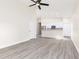 Open-concept living area featuring gray wood-look floors and a kitchen with white cabinetry at 414 Ellsworth St, Daytona Beach, FL 32114