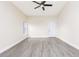 Spacious living room with gray wood-look flooring, ceiling fan, and bright natural light at 414 Ellsworth St, Daytona Beach, FL 32114