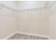 Well-lit walk-in closet featuring wire shelving and durable wood-look flooring at 414 Ellsworth St, Daytona Beach, FL 32114