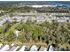 This aerial view shows the lovely community with its pond and well-maintained single Gathering homes at 4282 Alice St, Edgewater, FL 32141