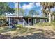 Screened in back patio with view of mature trees and green lawn at 4282 Alice St, Edgewater, FL 32141
