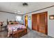 Cozy bedroom featuring a vibrant flamingo-patterned bedspread and classic wooden closet doors at 4282 Alice St, Edgewater, FL 32141