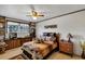 Bedroom features a ceiling fan, a window, hardwood furnishings, and tiger themed decor at 4282 Alice St, Edgewater, FL 32141