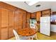 Charming kitchen with wood cabinets, a round dining table, and ample storage space at 4282 Alice St, Edgewater, FL 32141