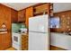 Kitchen area featuring vintage appliances, wood cabinetry and room for a deep freezer at 4282 Alice St, Edgewater, FL 32141