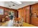 Kitchen with wood-paneled walls, a round dining table and a view to the backyard at 4282 Alice St, Edgewater, FL 32141