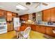 Vintage-style kitchen with wood cabinets, retro appliances, and an eat-in dining table at 4282 Alice St, Edgewater, FL 32141