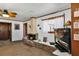 Living room showcasing a brick fireplace, ceiling fan, and TV with bright decorations at 4282 Alice St, Edgewater, FL 32141