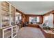Comfortable living room featuring built in daybed, wood paneling and shelves at 4282 Alice St, Edgewater, FL 32141