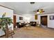 A large living room featuring carpet, ceiling fan, and wooden trim at 4282 Alice St, Edgewater, FL 32141