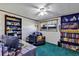 Office with ceiling fan, desk, bookcases, chair, and window overlooking a yard at 4282 Alice St, Edgewater, FL 32141