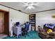 Office boasts a ceiling fan, chair, desk, and blue bookcase with view to the outside at 4282 Alice St, Edgewater, FL 32141