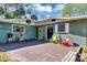 Open patio with sitting area and view of mature trees and the home's exterior at 4282 Alice St, Edgewater, FL 32141
