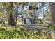 Outdoor storage shed in wooded backyard with ferns and palm trees at 4282 Alice St, Edgewater, FL 32141