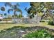 Spacious backyard showcasing a white picket fence, patio area, and lush green lawn at 435 N Oak Ave, Orange City, FL 32763