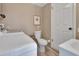 Bathroom featuring a toilet, sink, and a modern washing machine setup at 435 N Oak Ave, Orange City, FL 32763