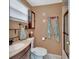Well-lit bathroom with vanity, decorative towels, a toilet, and a glass-enclosed shower at 435 N Oak Ave, Orange City, FL 32763