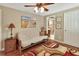 Cozy bedroom featuring a futon, ceiling fan, and access to the bathroom at 435 N Oak Ave, Orange City, FL 32763