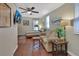 Cozy bedroom with wood floors, ceiling fan, and a large window letting in light at 435 N Oak Ave, Orange City, FL 32763