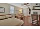 Bedroom featuring wood floors, ceiling fan, and a dining area with 2 chairs at 435 N Oak Ave, Orange City, FL 32763