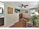 Comfortable bedroom featuring wood floors, ceiling fan, and a view to the bathroom at 435 N Oak Ave, Orange City, FL 32763