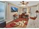 Bright bedroom featuring a ceiling fan, a work station, and hardwood floors at 435 N Oak Ave, Orange City, FL 32763