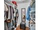 Walk-in closet with hanging racks, shelves, and a mirrored door to another room at 435 N Oak Ave, Orange City, FL 32763