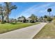 Beautiful home featuring a long driveway, green lawn, and mature landscaping at 435 N Oak Ave, Orange City, FL 32763