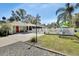 Charming home with a red door, white picket fence, and mature trees at 435 N Oak Ave, Orange City, FL 32763