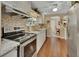 Modern kitchen with stainless steel appliances, white cabinets, and stone countertops at 435 N Oak Ave, Orange City, FL 32763
