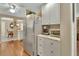 Bright kitchen featuring stainless steel appliances, white cabinetry, and hardwood flooring at 435 N Oak Ave, Orange City, FL 32763