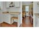 Bright kitchen with white cabinets, marble countertops, and natural wood flooring at 435 N Oak Ave, Orange City, FL 32763