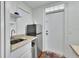 Kitchenette with sink, granite countertops, mini fridge, and white cabinets at 435 N Oak Ave, Orange City, FL 32763